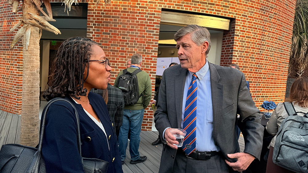 Two attendees talk outside between sessions at the 2026 UF Law E-Discovery Conference.