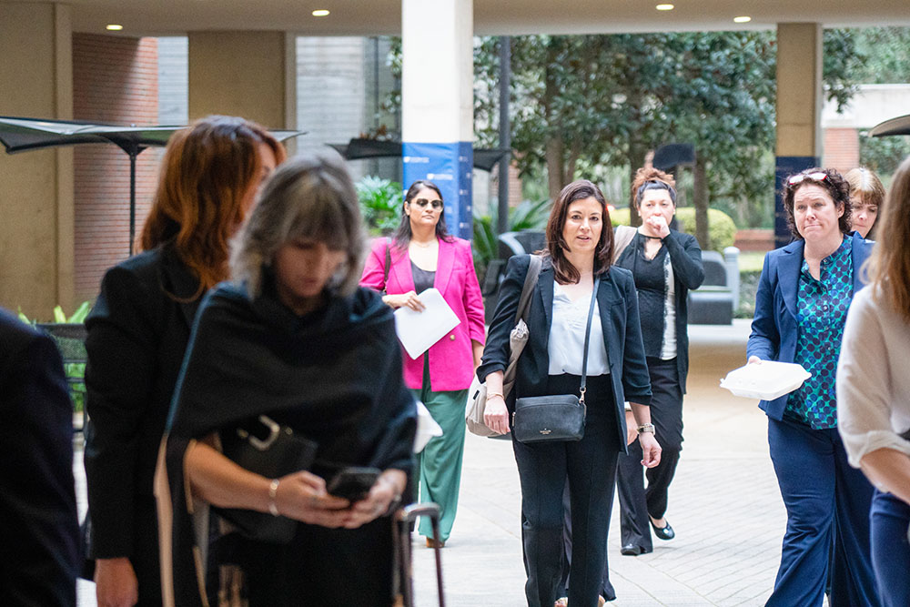Conference participants arrive at the University of Florida Levin College of Law for the in-person program.
